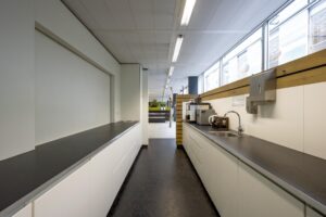 Modern office kitchenette at Jacob Bontiusplaats with coffee machines, sink, and ample counter space.